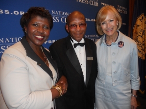 Fans Gwen Ifill and Judy Woodruff, PBS anchors, flank head table waiter Andrew Price on July 24 at the final luncheon of his 45-year career.