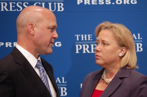 The Landrieus confer before the mayor's Press Club luncheon address.