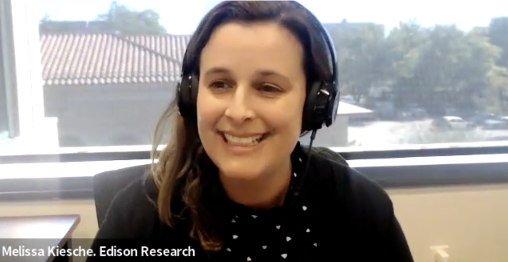 Screen shot of a smiling woman with brown hair