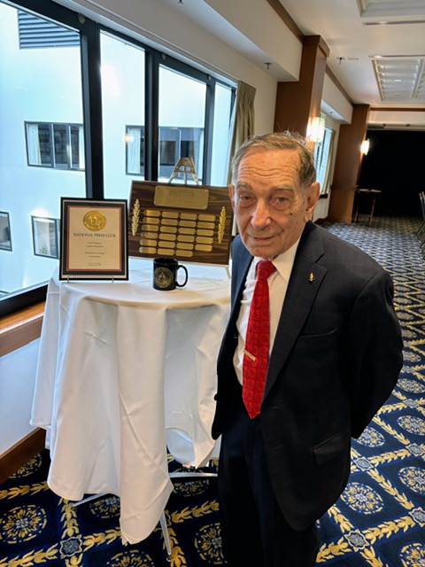 Photo of Irv Chapman with awards