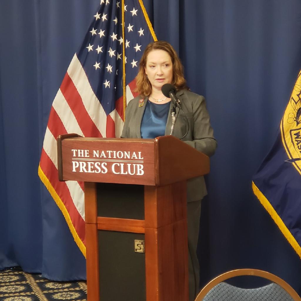 Photo of Club President Eileen O'Reilly at General Membership Meeting.