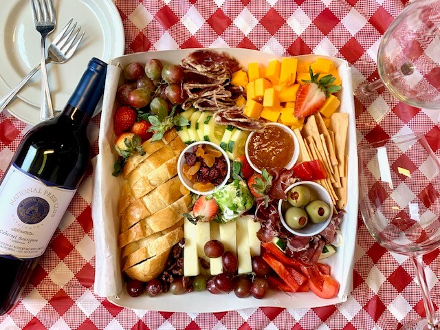 Grazing box of cheeses and fruit.