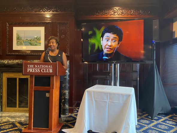 Photo of Club President Lisa Matthews celebrating Maria Ressa's Nobel Prize.